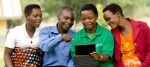 Healthy Entrepreneurs community engaging with digital tablet outdoors.